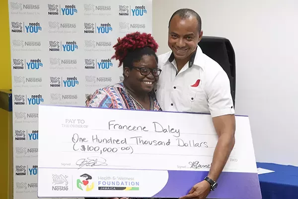 Nestle Jamaica Supply Chain Manager Linton Johnson presenting the Nestle Needs Youth 2019 Top Summer Intern Francene Daley